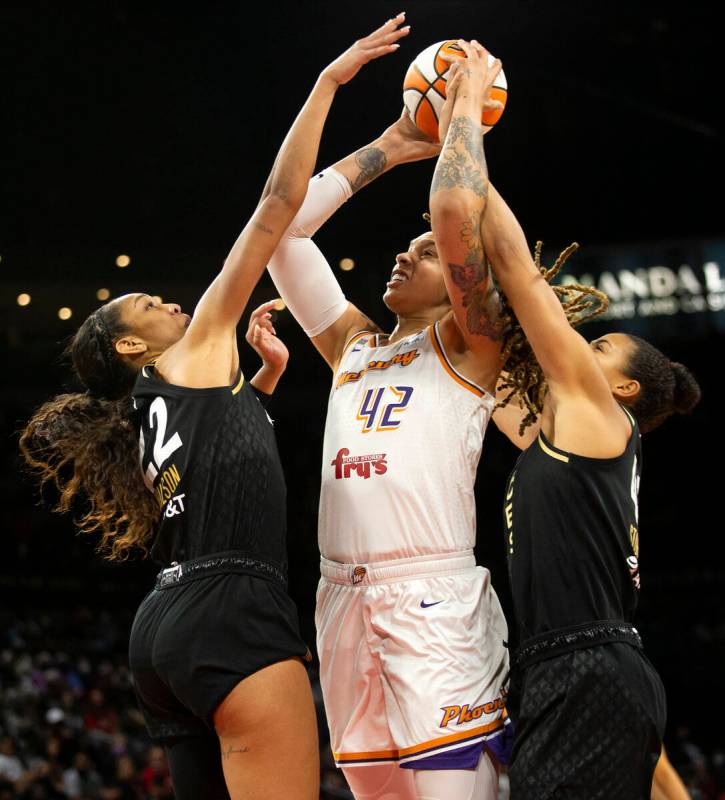 Las Vegas Aces forward A'ja Wilson (22) and center Kiah Stokes (41) attempt to thwart a point b ...