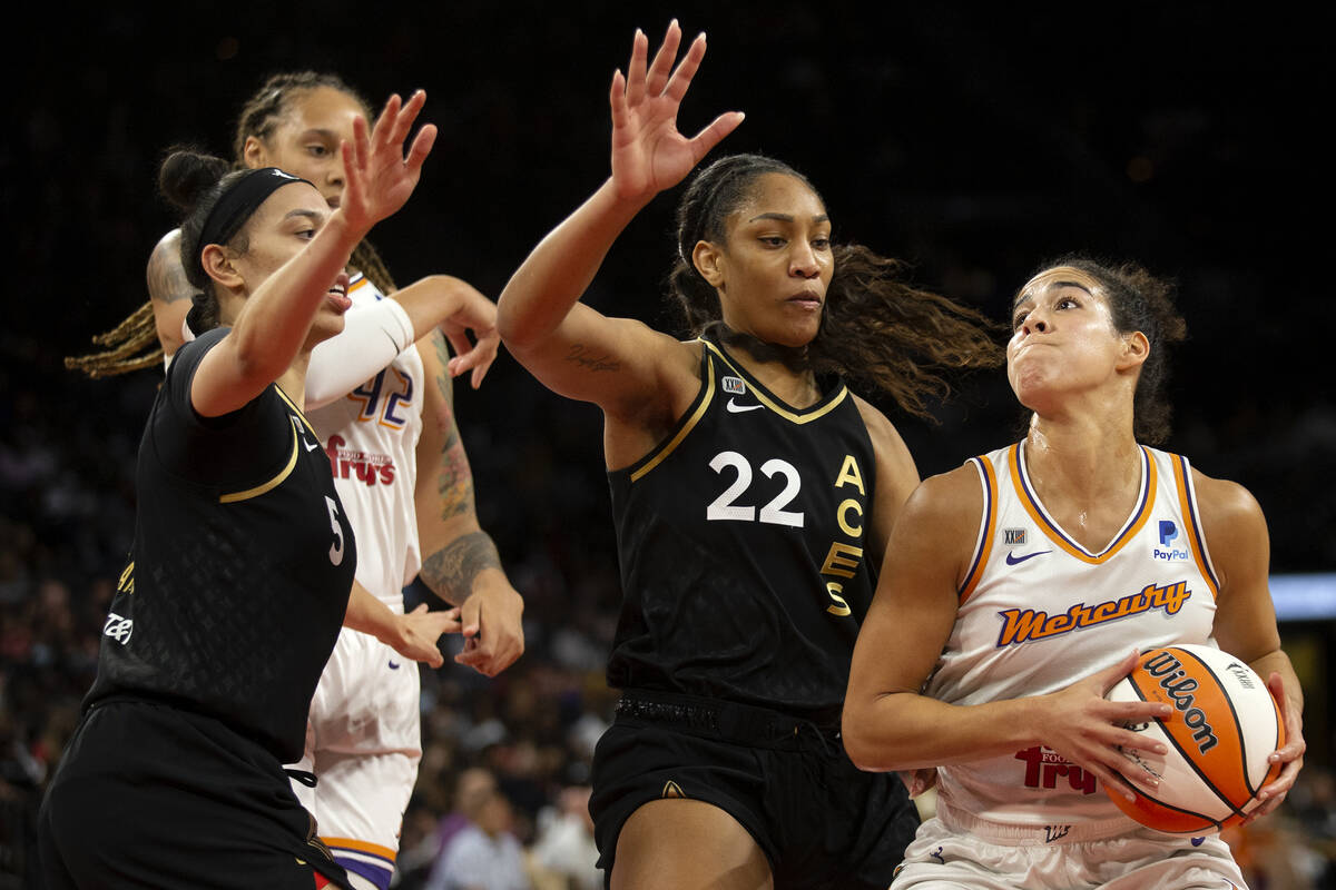 Las Vegas Aces forward A'ja Wilson (22) defends as Phoenix Mercury guard Kia Nurse (0) jumps to ...