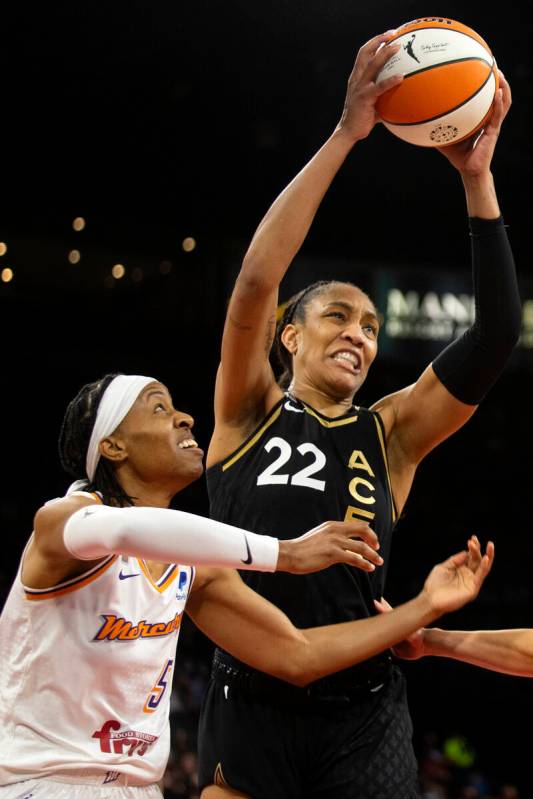 Las Vegas Aces forward A'ja Wilson (22) gains control of the ball as Phoenix Mercury guard Shey ...