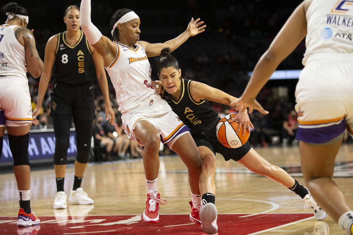 Las Vegas Aces guard Kelsey Plum (10) dribbles around Phoenix Mercury guard Shey Peddy (5) duri ...