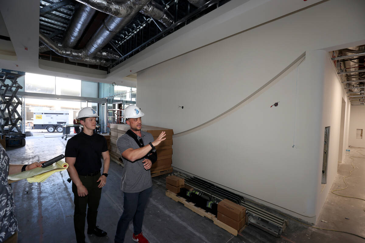 Developers Neil Sansone, left, and Miles Sansone show the lobby of Axiom, a new office complex ...