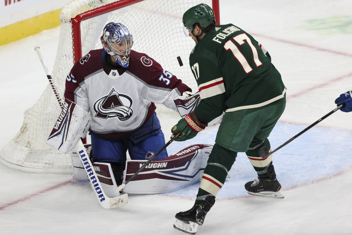 Colorado Avalanche's goalie Darcy Kuemper (35) watches the puck fly in front of Minnesota Wild' ...