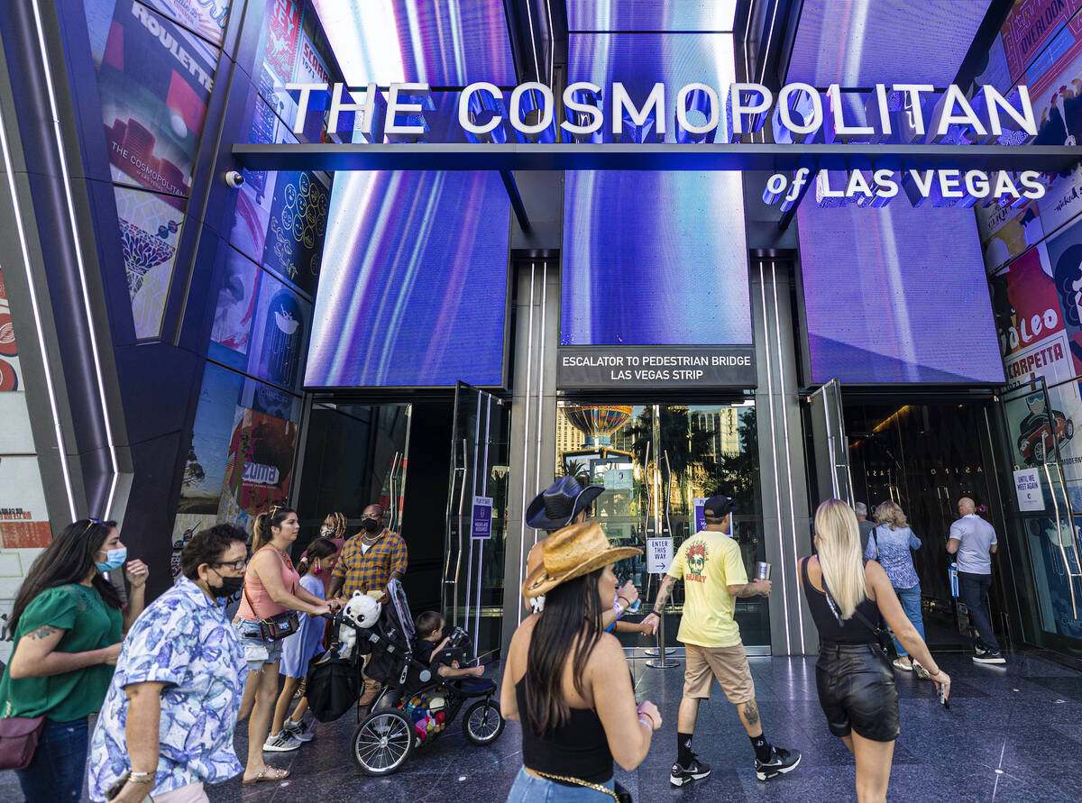 Pedestrians walk past The Cosmopolitan of Las Vegas on Monday, Sept. 27, 2021, in Las Vegas. (B ...