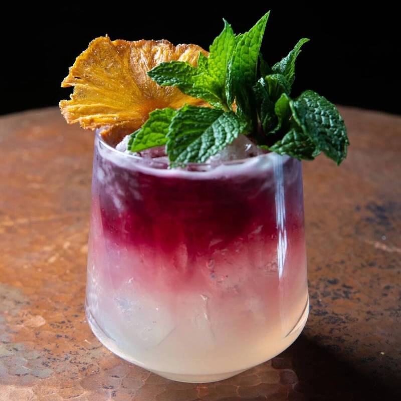 Serenade starts Bacardi Dragonberry, Singani62, passionfruit-basil syrup and lemon with a red w ...