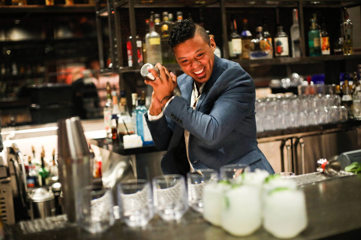 Ricky Lin, director of sales for Singani 63, shakes a cocktail at the Magic Mike Lounge at the ...