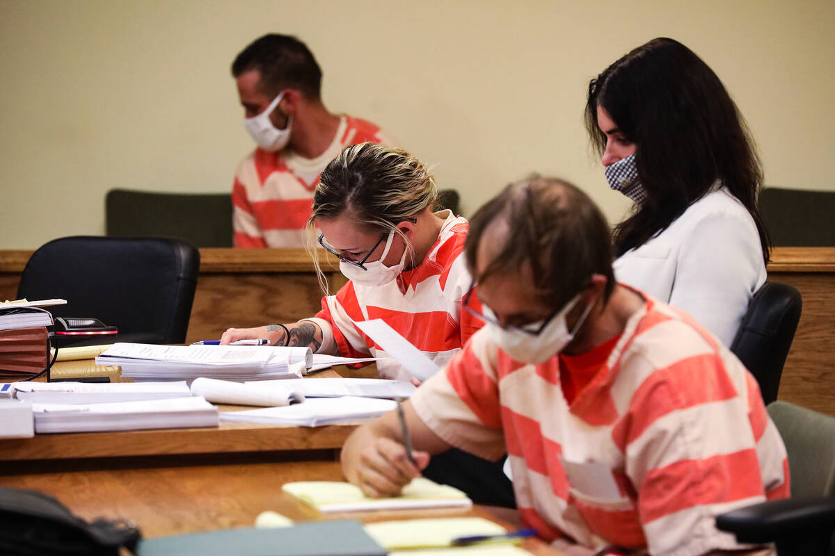 From far left, Kevin Dent, Heather Pate, center, and Brad Mehn, right, sit in court for their p ...