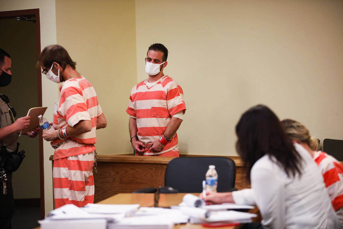 Brad Mehn, left, and Kevin Dent, center, get ready to be led out the courtroom on Friday, Oct. ...