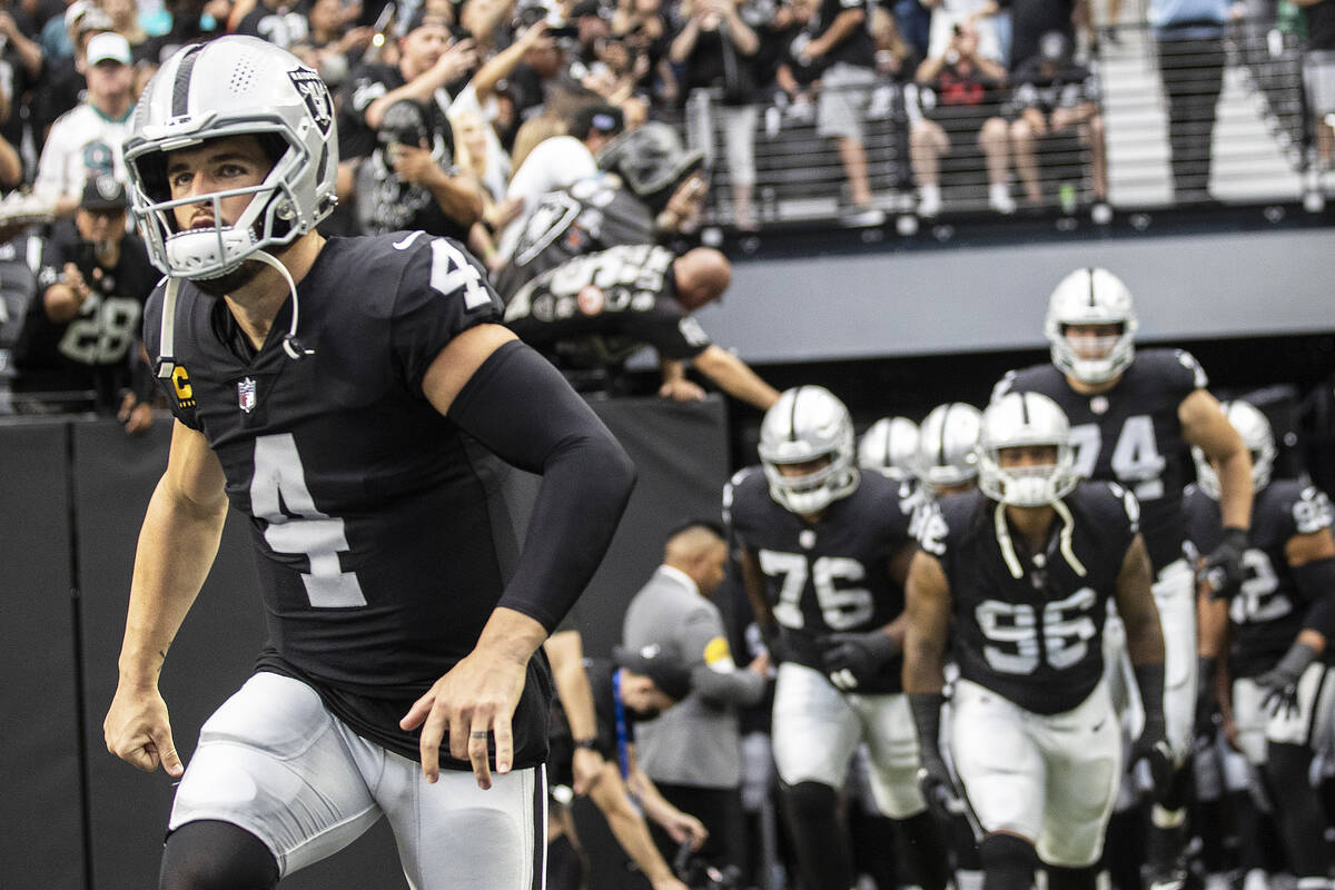 Las Vegas Raiders quarterback Derek Carr (4) leads his team on the field before the start of an ...