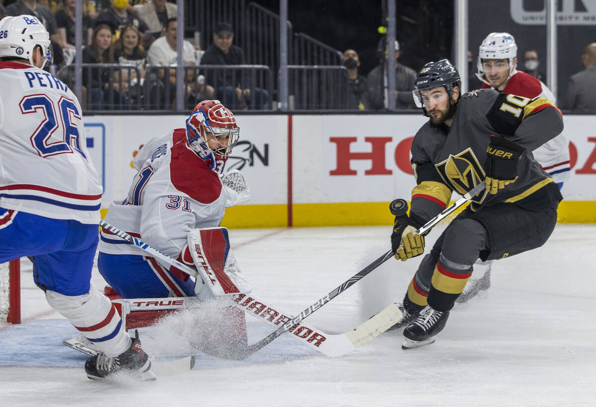 Golden Knights center Nicolas Roy (10) has a shot rejected by Montreal Canadiens goaltender Car ...