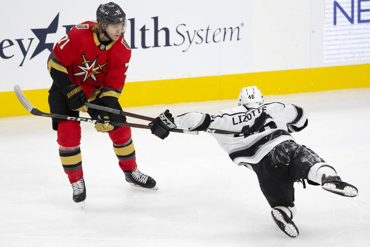 Golden Knights center William Karlsson (71) shakes 0ff Kings center Blake Lizotte (46) as he ha ...