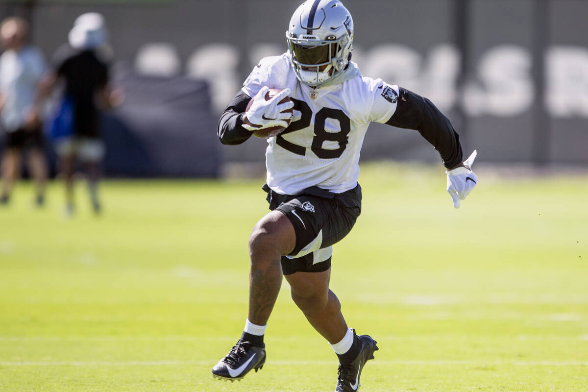 Raiders running back Josh Jacobs (28) runs with the football during a practice session at the R ...