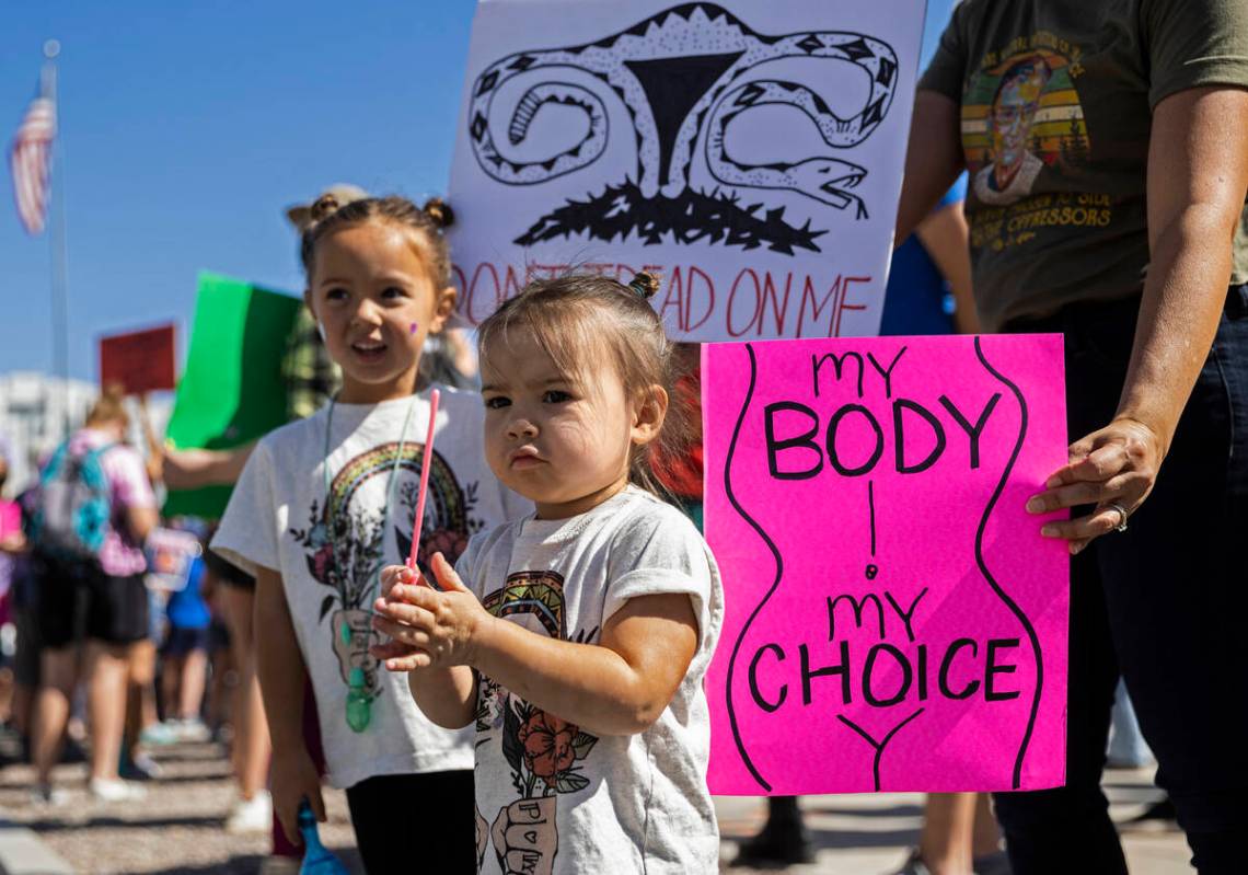 Stella , right, 2, and Grace Thompson, 4, demonstrate outside the Lloyd D George Courthouse dur ...