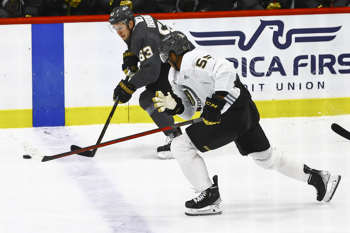 Golden Knights' Evgenii Dadonov (63) skates with the puck under pressure from Keegan Kolesar (5 ...