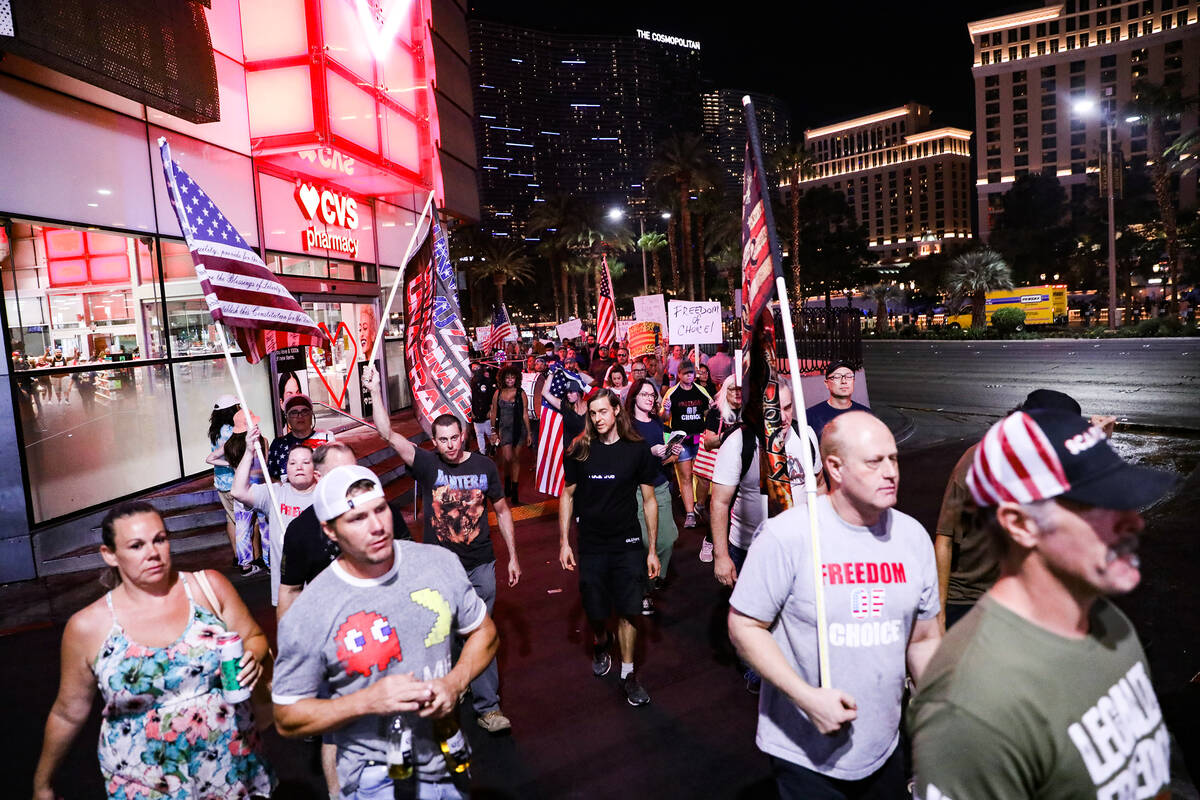 Protesters walk the Strip to protest COVID-19 government mandates, hosted by the non-profit Fre ...