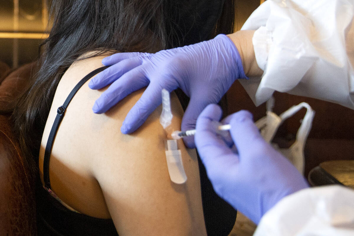 Audrey Vallapudua, of Las Vegas, receives the Pfizer COVID-19 vaccine during a pop-up vaccinati ...