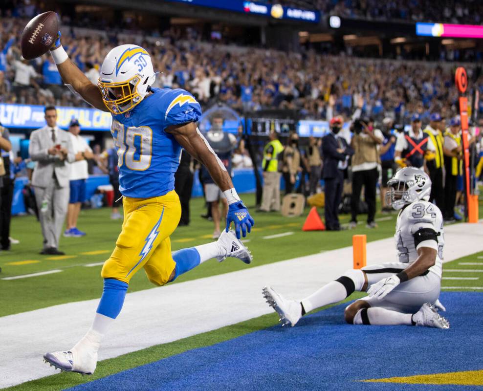 Los Angeles Chargers running back Austin Ekeler (30) scores a touchdown past Raiders outside li ...