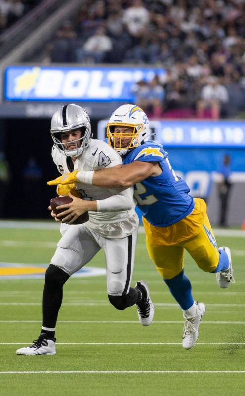 Raiders quarterback Derek Carr (4) is sacked by Los Angeles Chargers linebacker Kyler Fackrell ...