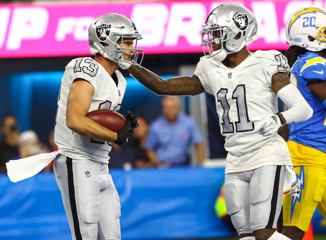 Raiders wide receiver Henry Ruggs III (11) celebrates a touchdown by wide receiver Hunter Renfr ...