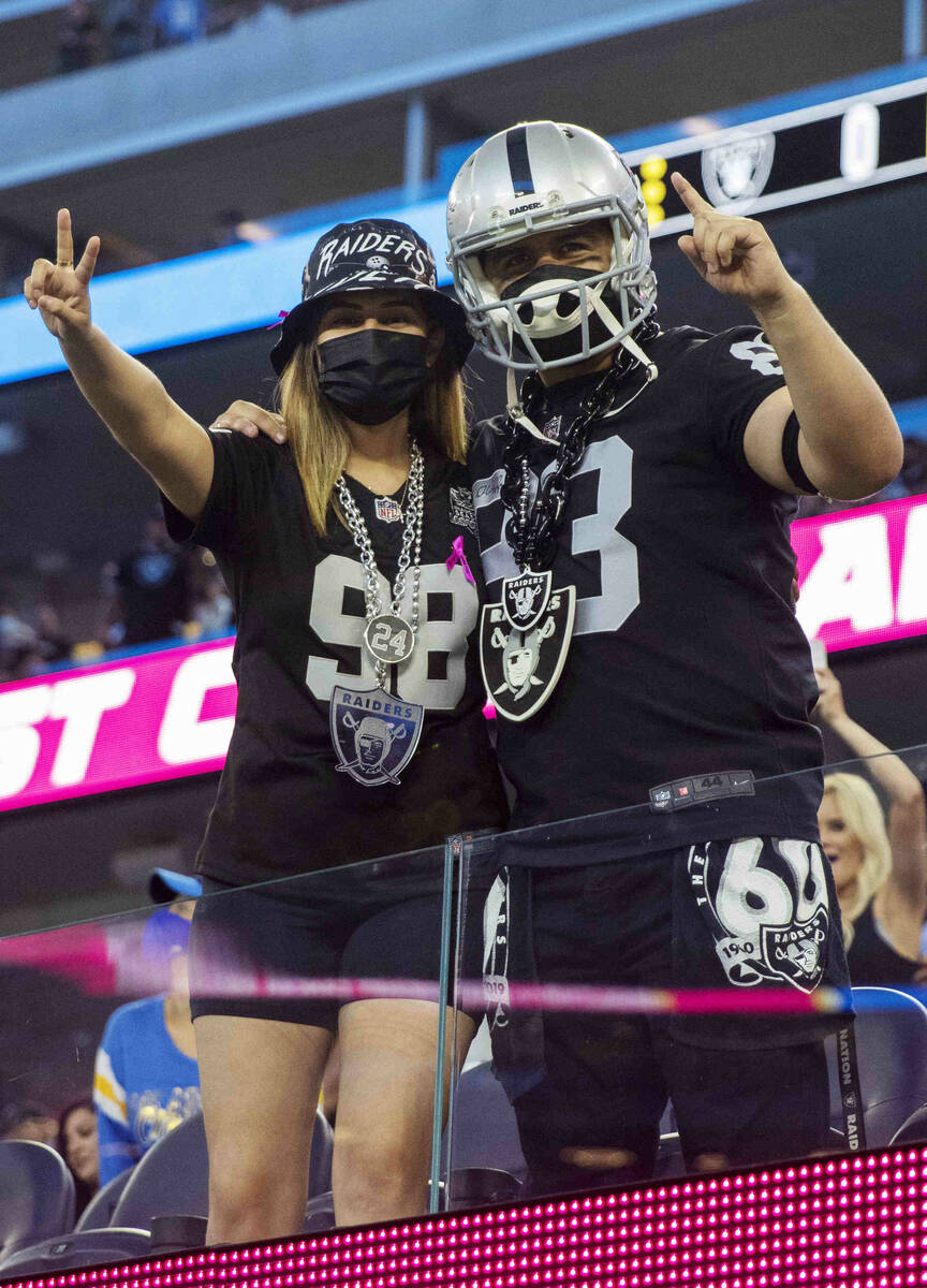 Raiders fans pose for a photo before an NFL football game between the Raiders and the Los Angel ...