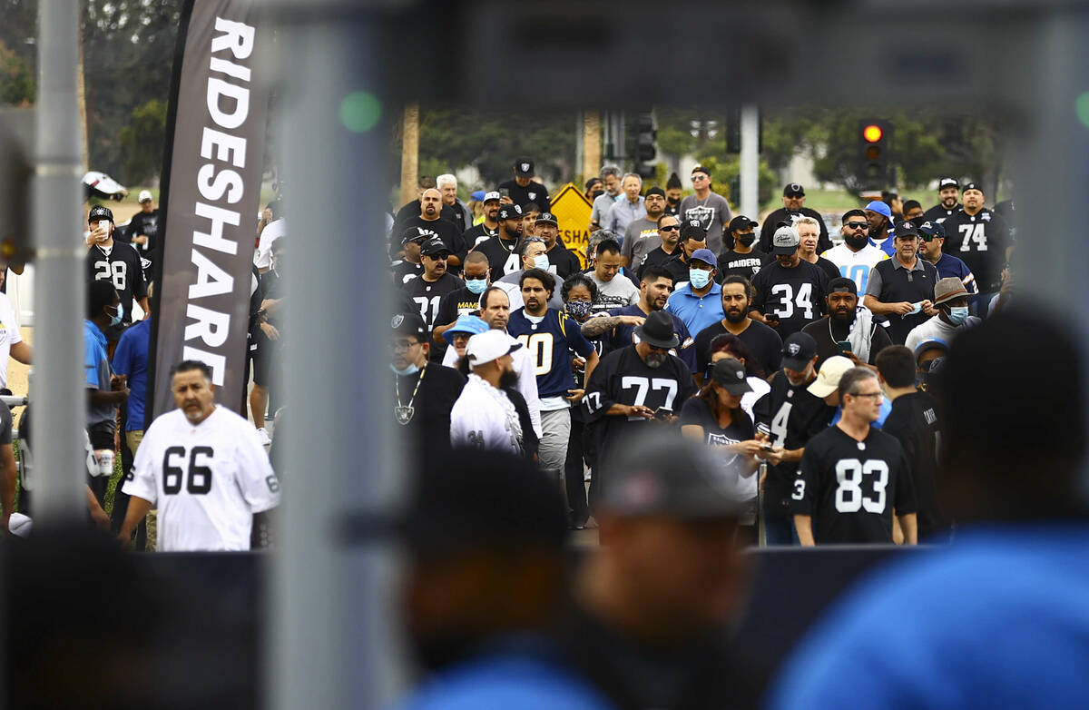 Raiders fans make their way to SoFi Stadium before the start of an NFL game against the Los Ang ...