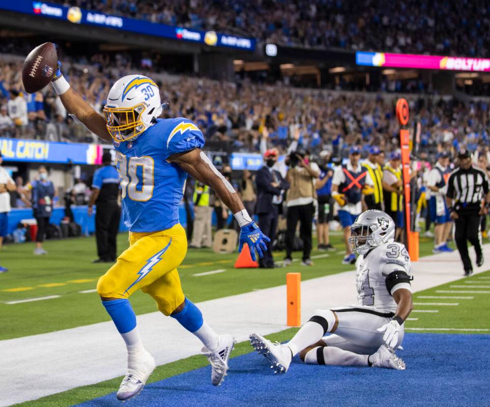 Los Angeles Chargers running back Austin Ekeler (30) scores a touchdown past Raiders outside li ...