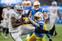 Raiders tight end Darren Waller (83) makes a catch against Los Angeles Chargers defensive back ...