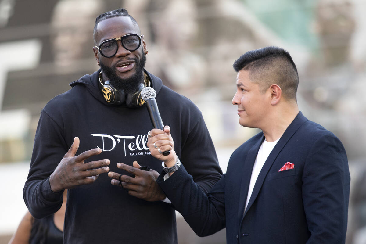 Heavyweight champion Deontay Wilder speaks with Ray Flores during a press conference at Toshiba ...