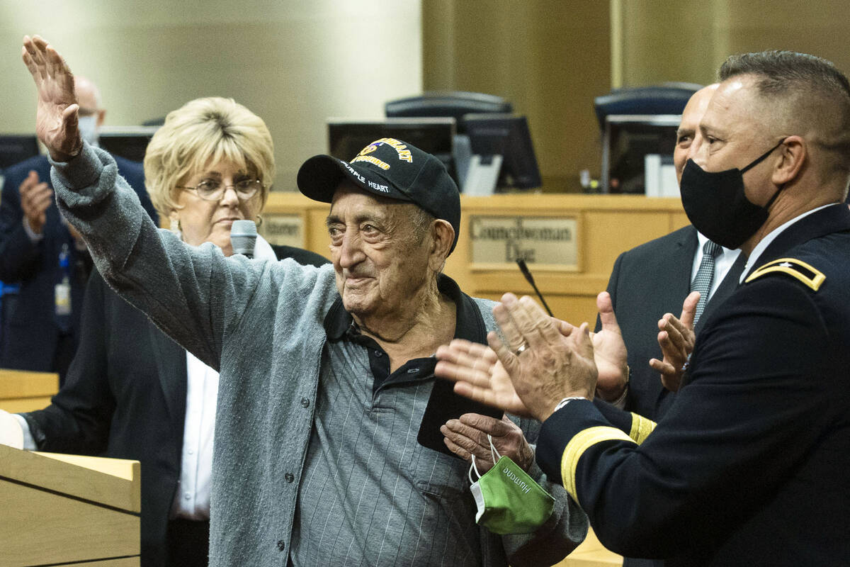A 98-year-old World War II veteran, Onofrio Zicari, left, acknowledges the crowed after receivi ...