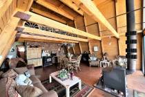 The 1,344-square-foot alpine-designed cabin is powered by a generator. A wood stove provides th ...