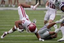 Oklahoma tight end Jeremiah Hall (27) is knocked down by Kansas State defensive back Jahron McP ...
