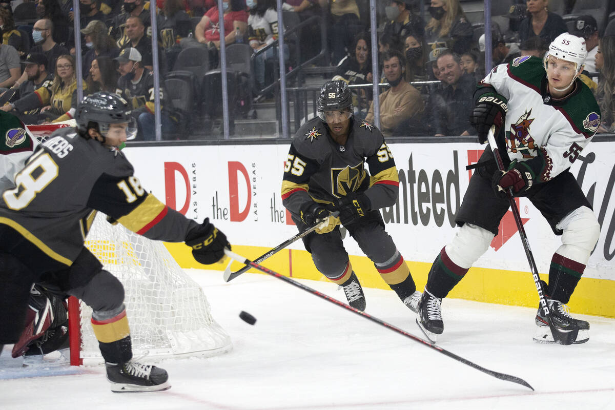 Golden Knights left wing Peyton Krebs (18) and right wing Keegan Kolesar (55) skate to defend w ...