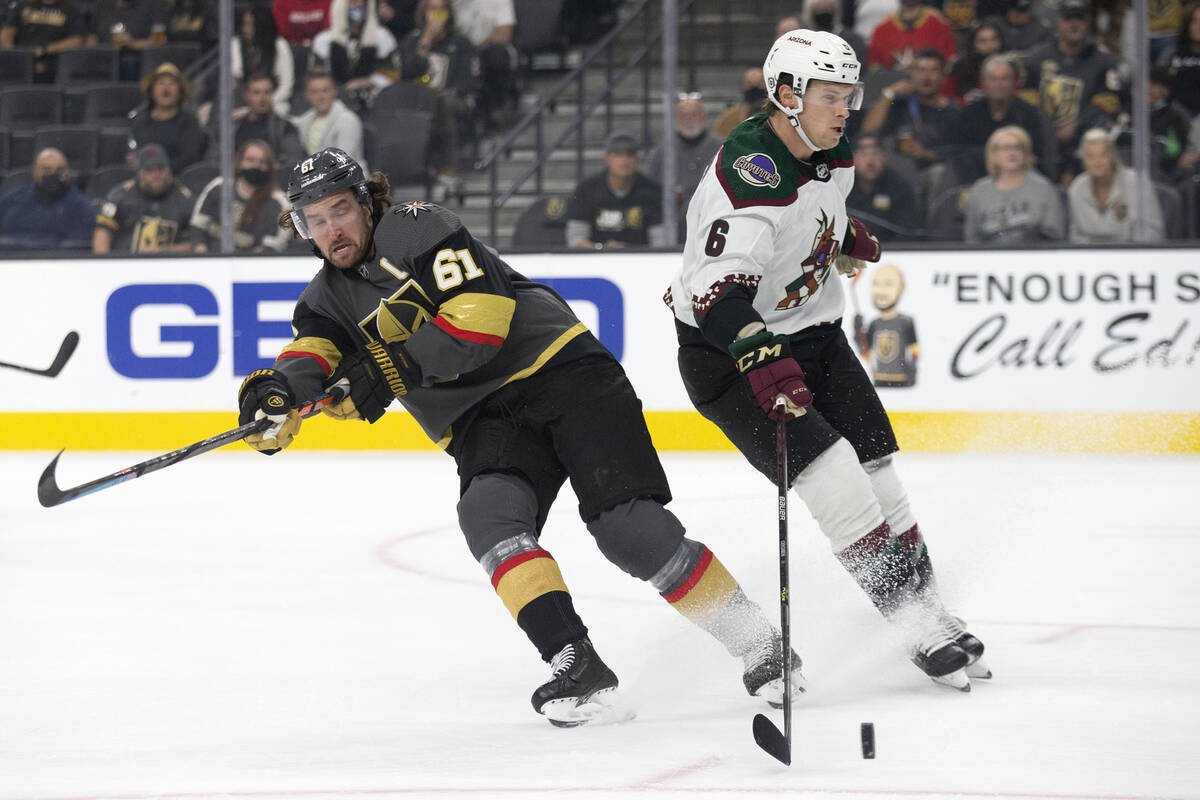 Golden Knights right wing Mark Stone (61) loses control of the puck to Coyotes defenseman Jakob ...