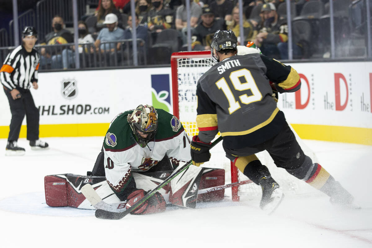 Coyotes goaltender Karel Vejmelka (70) saves a shot on goal by Golden Knights right wing Reilly ...