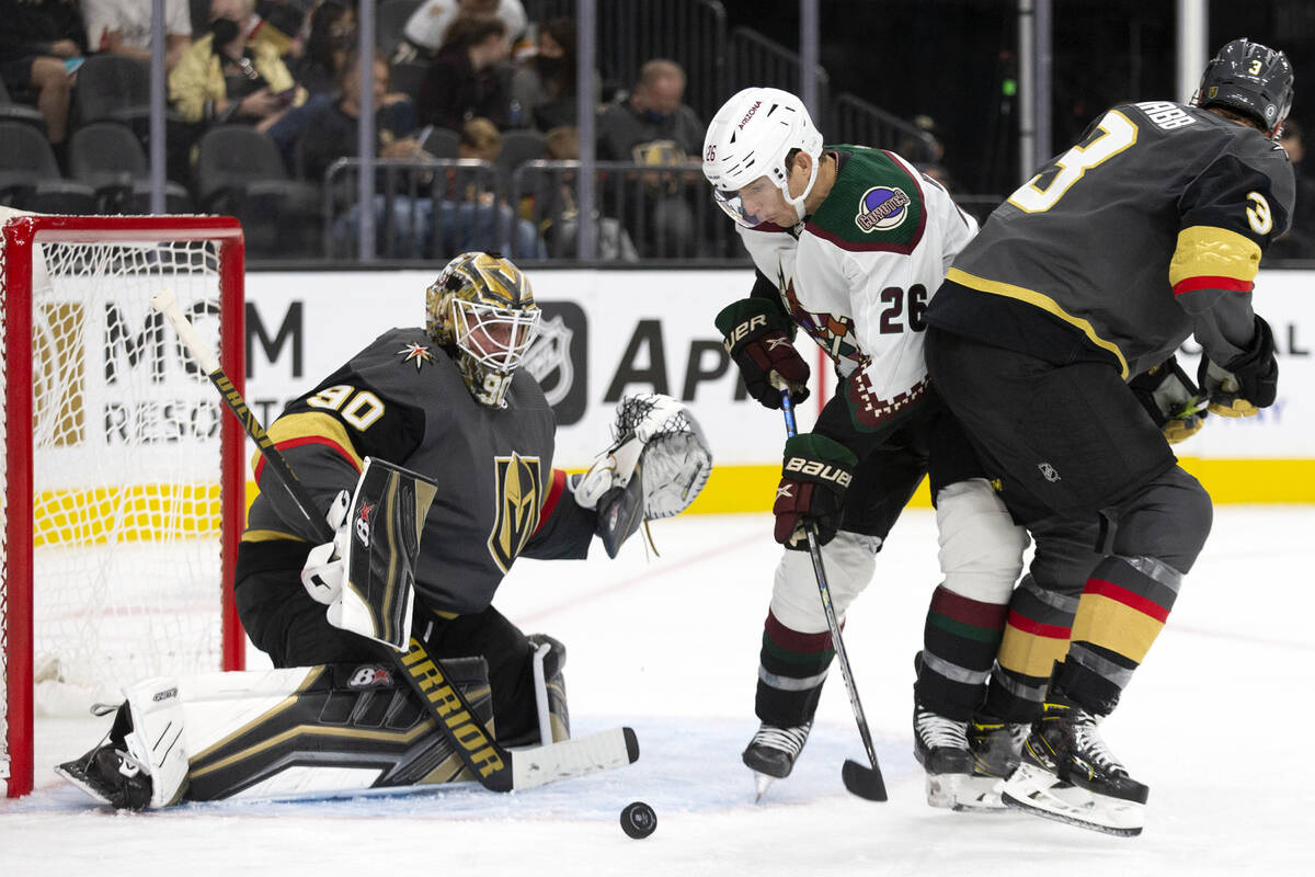 Coyotes left wing Antoine Roussel (26) attempts to shoot a goal as Golden Knights goaltender Ro ...