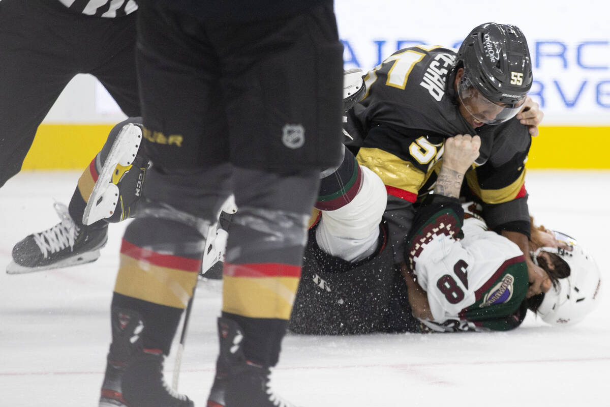 Golden Knights right wing Keegan Kolesar (55) and Coyotes forward Liam O'Brien (38) hit the ice ...