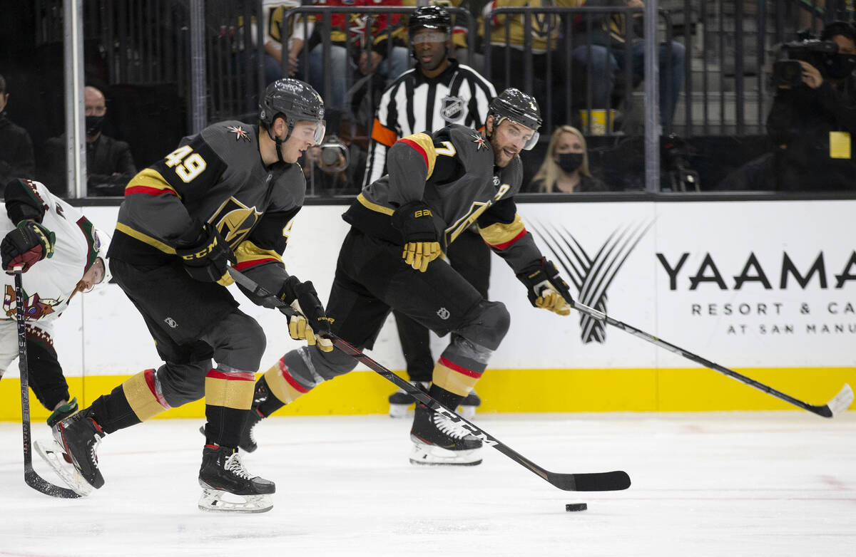 Golden Knights defenseman Peter DiLiberatore (49) and defenseman Alex Pietrangelo (7) skate tow ...