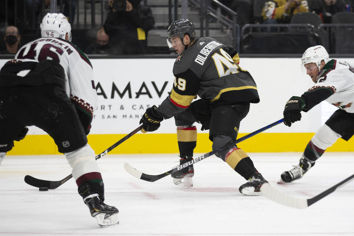 Golden Knights defenseman Peter DiLiberatore (49) skates with the puck as Coyotes center Ilya L ...