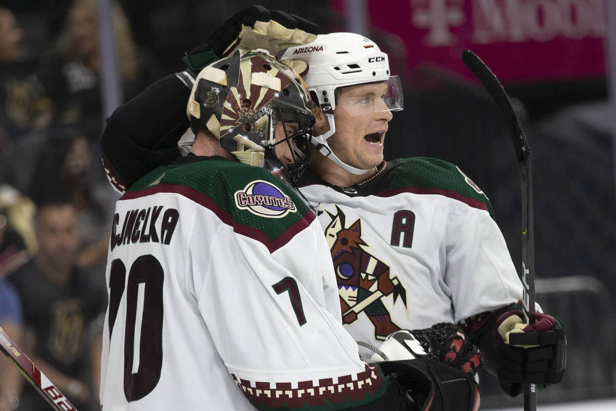 Coyotes defenseman Jakob Chychrun (6) congratulates goaltender Karel Vejmelka (70) on a win aga ...