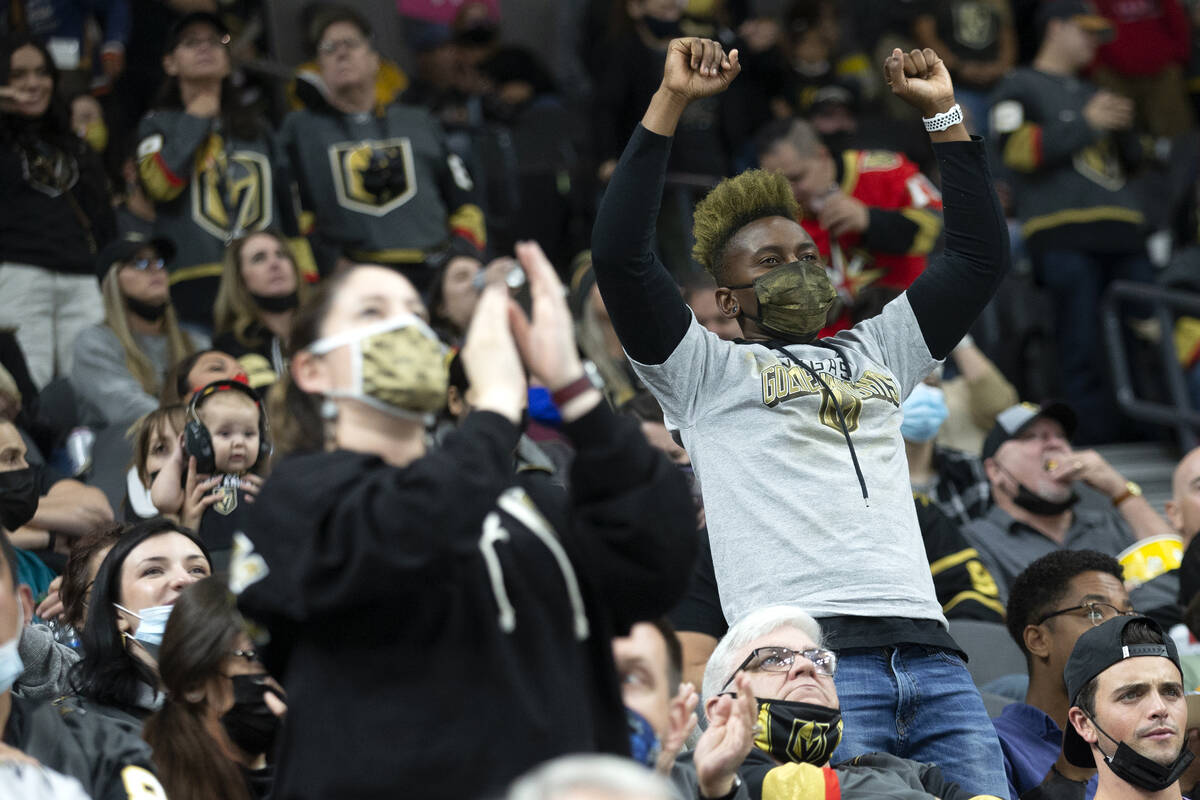 Golden Knights cheer for their team during the second period of a preseason NHL hockey game aga ...