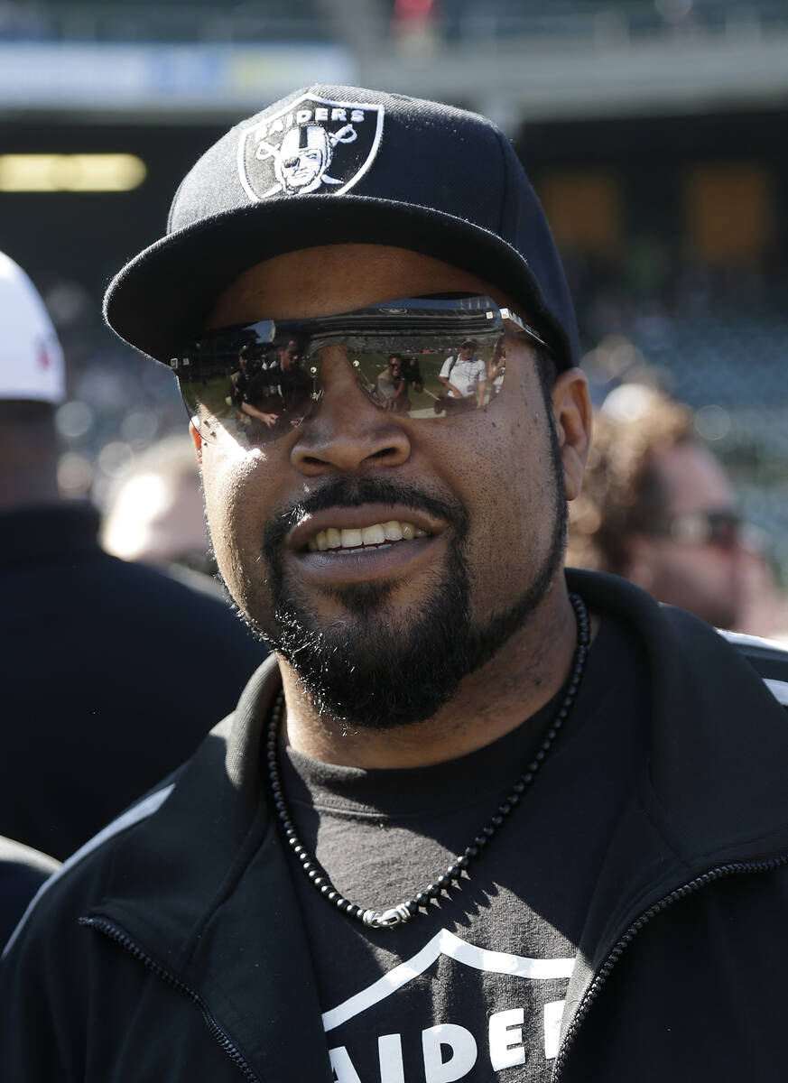 Rapper Ice Cube smiles before an NFL football game between the Oakland Raiders and the Arizona ...