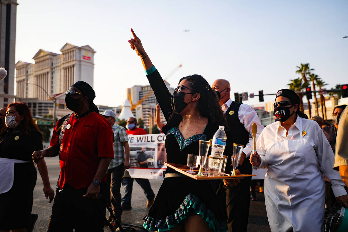 Cristina Kline chants as she marches with other members of the Culinary Workers Union Local 226 ...