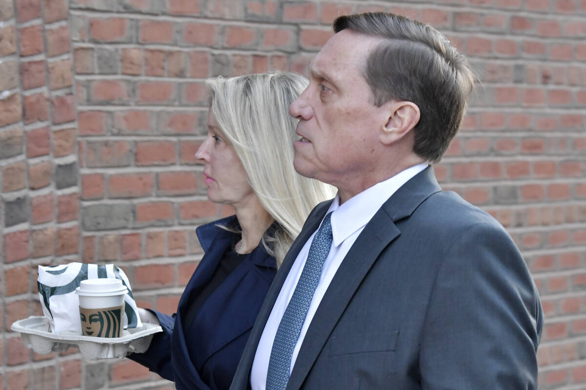 John Wilson and his wife arrive at federal court Thursday, Oct. 7, 2021, in Boston. Wilson and ...