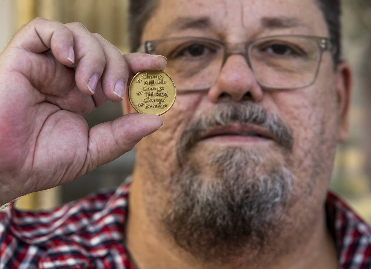 Henry Snyder displays the motivational coin he received following his graduation from Clark Cou ...