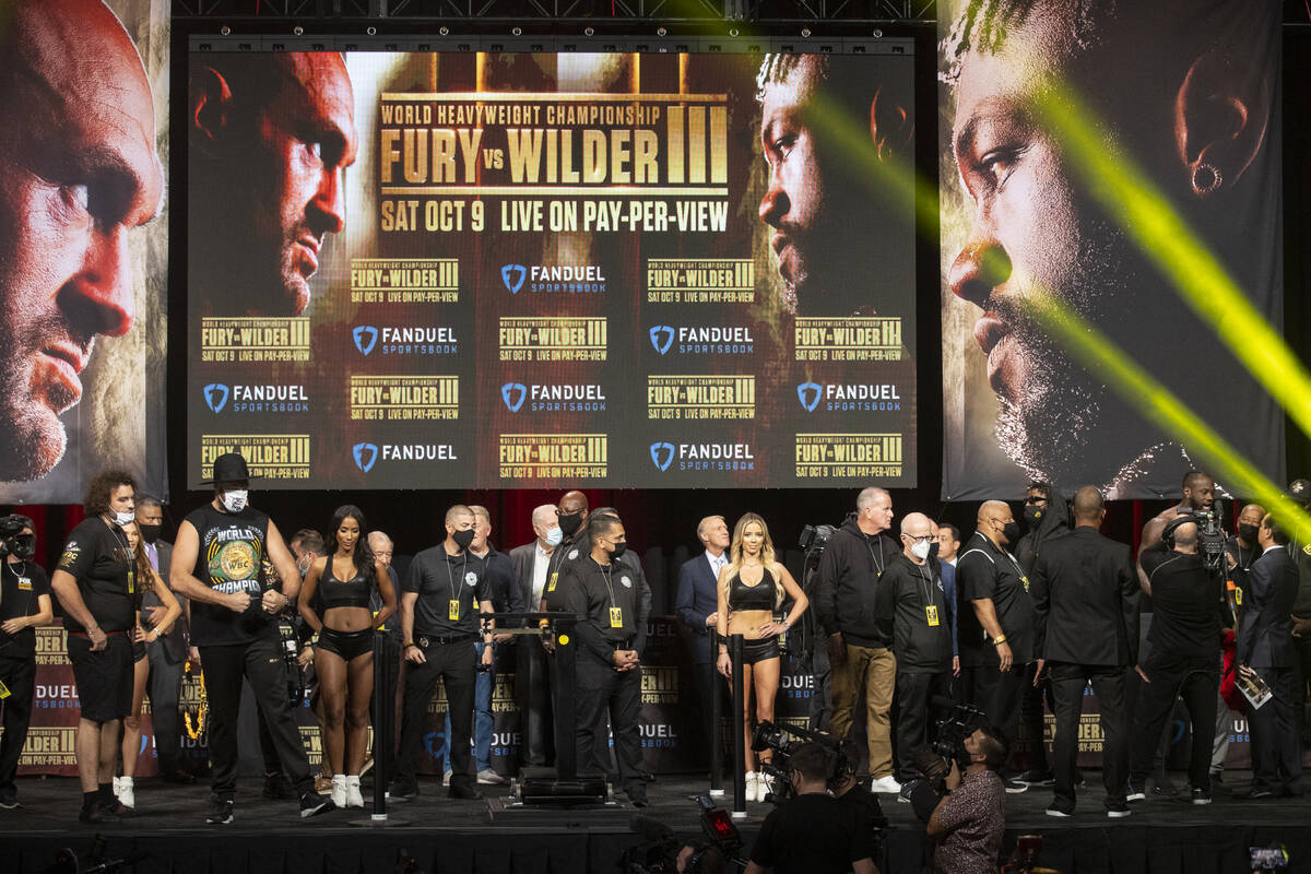 Tyson Fury and Deontay Wilder on stage during a weigh-in event at the MGM Grand Garden Arena in ...