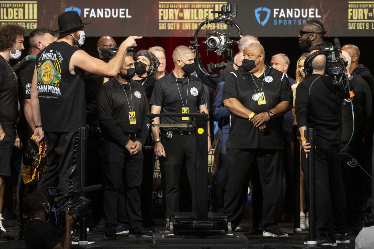Tyson Fury and Deontay Wilder meet on stage during a weigh-in event at the MGM Grand Garden Are ...