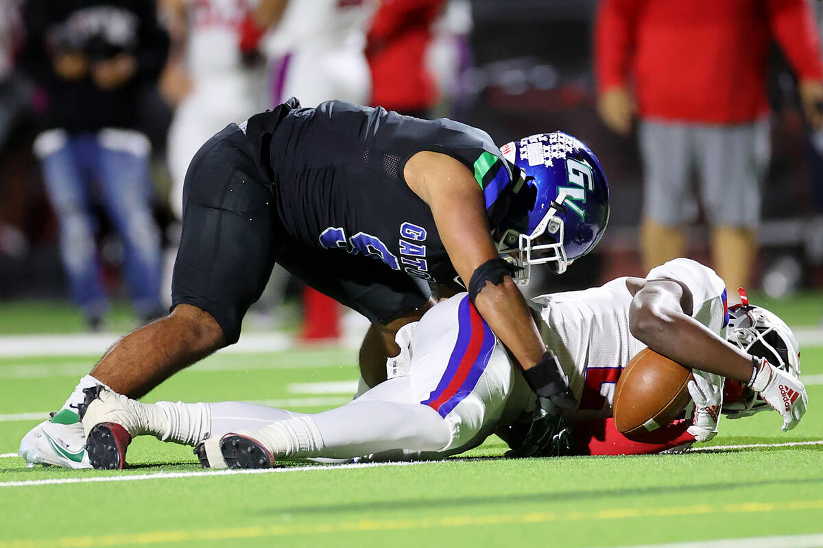 Liberty's Germie Bernard (2) is tackled by Green Valley's Mathius Aleaga during a two-point con ...