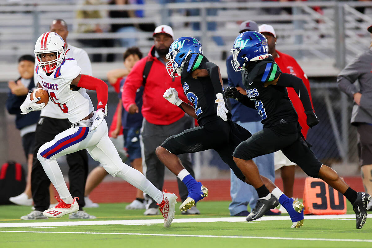 Liberty's Ethan Hilliard (16) runs the ball after a catch as Green Valley's Kendall Ayersman ( ...