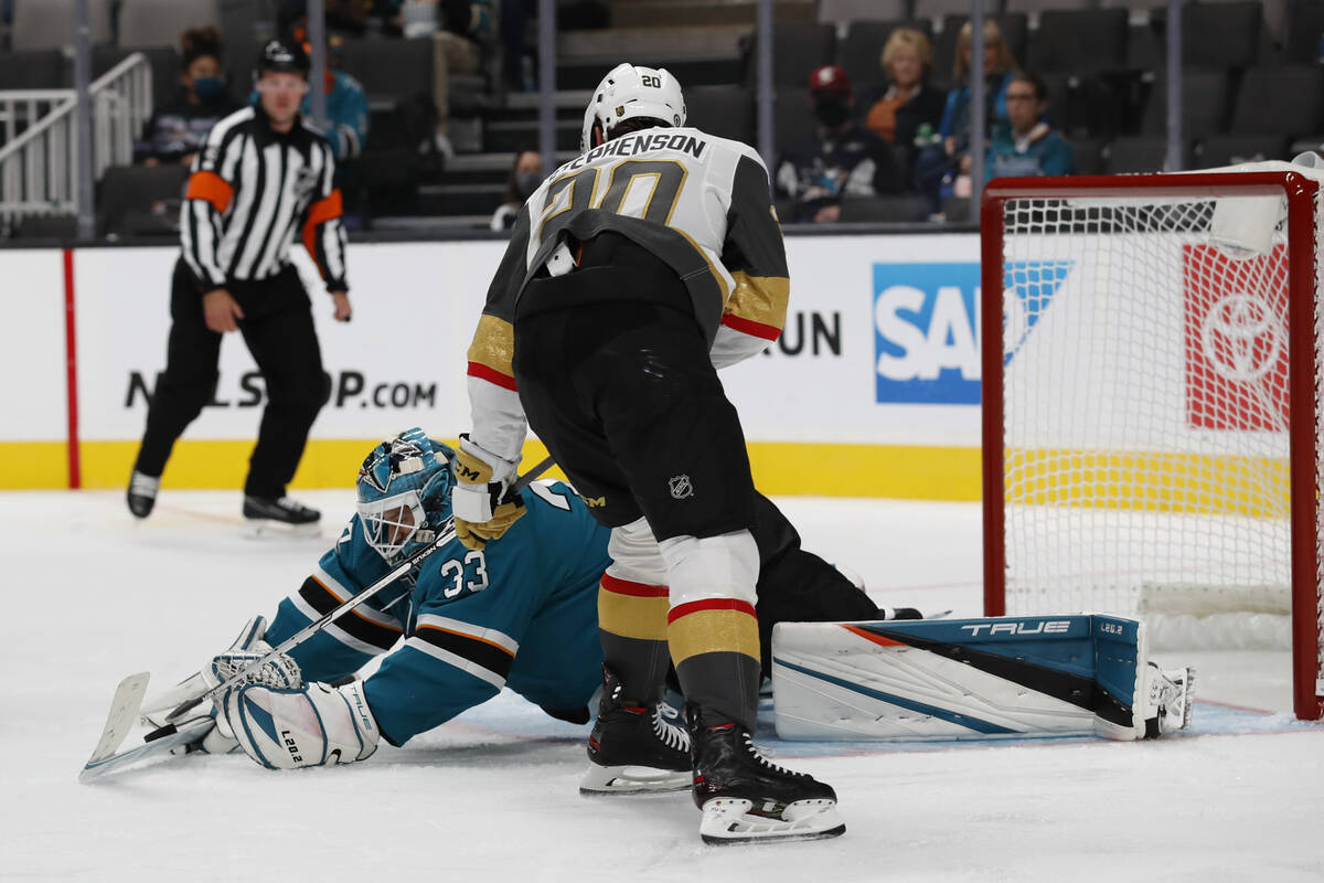 San Jose Sharks goaltender Adin Hill (33) makes a save against Vegas Golden Knights center Chan ...