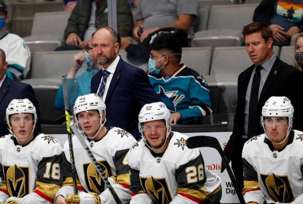 Vegas Golden Knights head coach Peter DeBoer, center left top, looks on as his team plays again ...