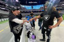 Neal Schon and Criss Angel greet each other during rehearsals Saturday at Allegiant Stadium for ...